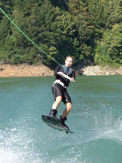 Brittney jumping the wake on wakeboard